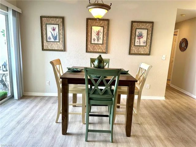 The dining area has plenty of room.  The screened balcony is to the left and the kitchen is to the right.