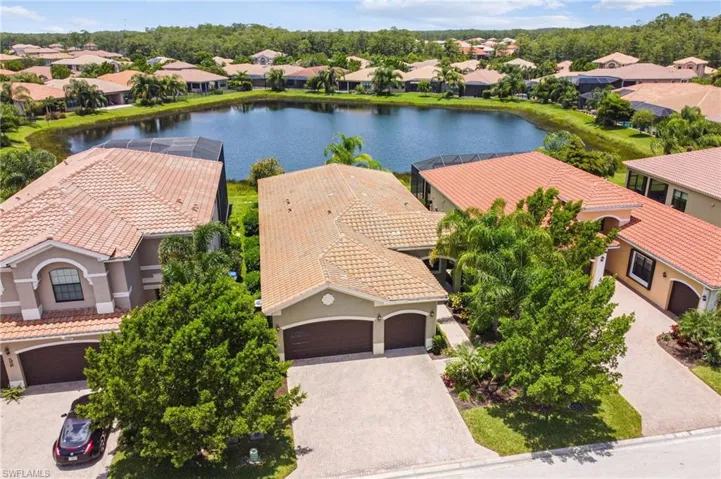 Aerial view of residential area featuring a nearby body of water