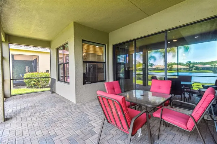 View of patio with outdoor dining area and a water view