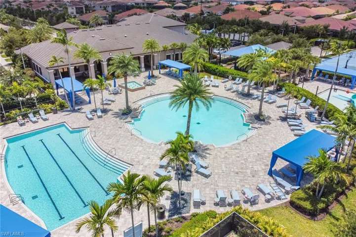 Community pool with a patio and a residential view
