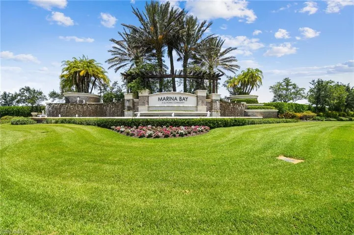 Community / neighborhood sign featuring a lawn