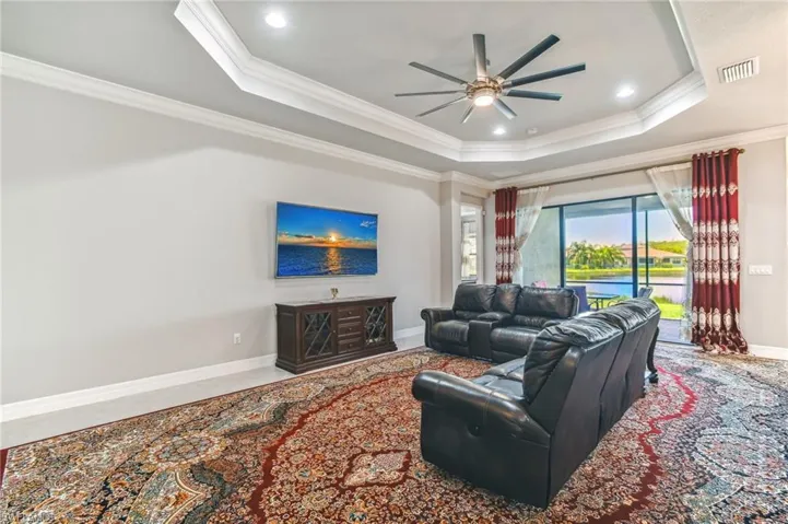 Living room featuring ornamental molding, a ceiling fan, and recessed lighting