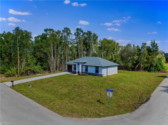 Ranch-style house with a garage and a front yard