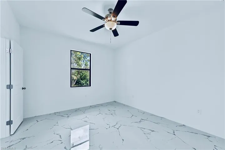 Unfurnished room featuring ceiling fan