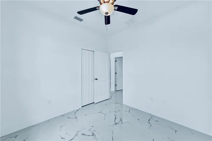 Unfurnished room featuring ceiling fan