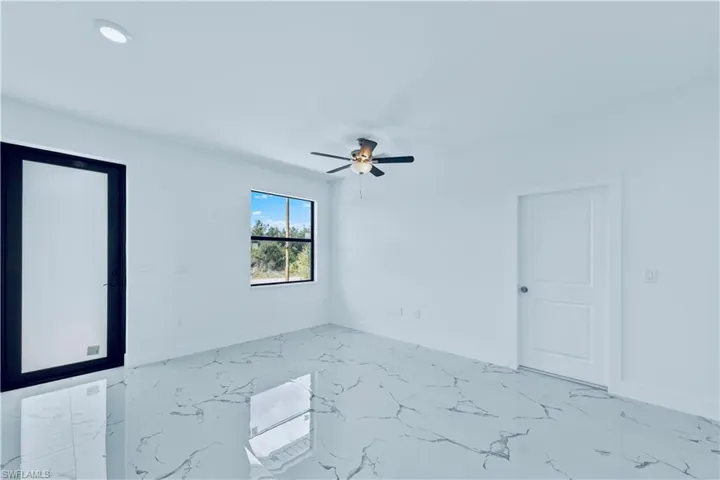 Spare room with ceiling fan