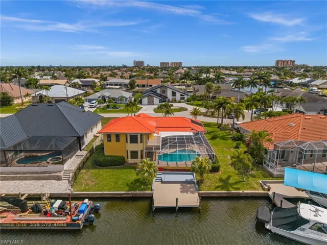 Aerial View of the back including dock, pool and lanai