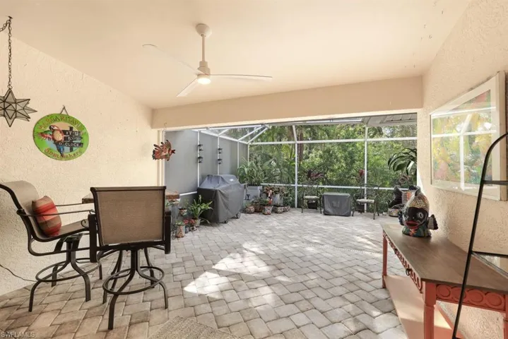 Sunroom / solarium featuring ceiling fan