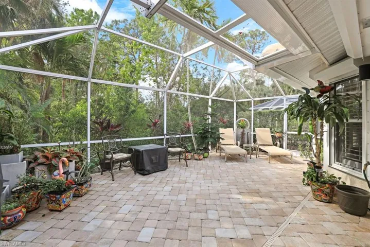 View of patio with a lanai