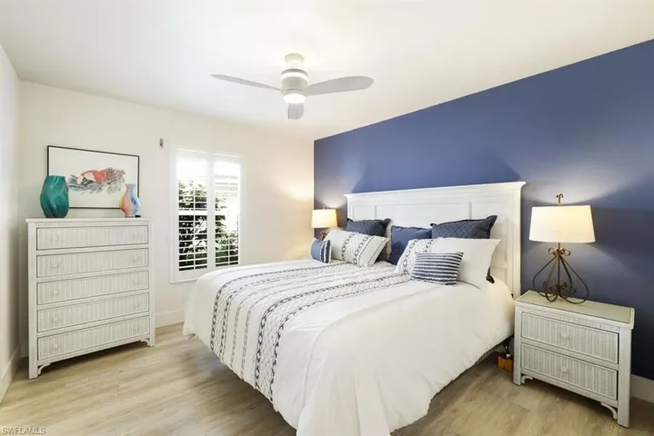 Bedroom with ceiling fan and light hardwood / wood-style flooring