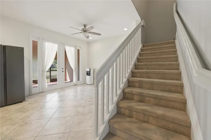 Stairs featuring french doors, ceiling fan, recessed lighting, and tile patterned flooring