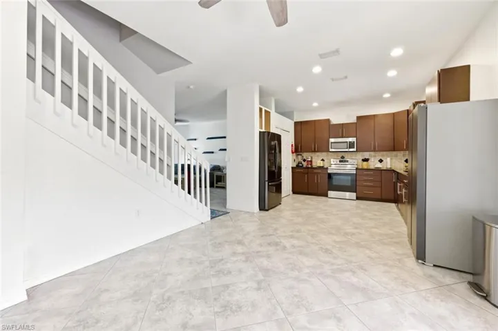 Kitchen with stainless steel appliances, ceiling fan, tasteful backsplash, recessed lighting, and light tile patterned floors