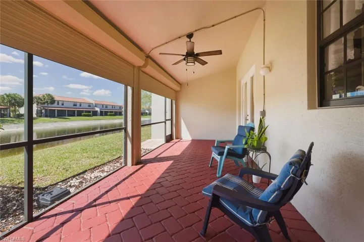 Sunroom with ceiling fan and a patio area