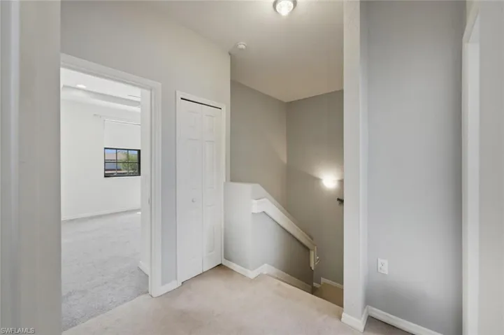 Staircase featuring carpet and baseboards