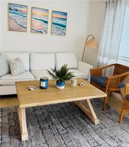 White walls with a textured area rug and wood-finish flooring