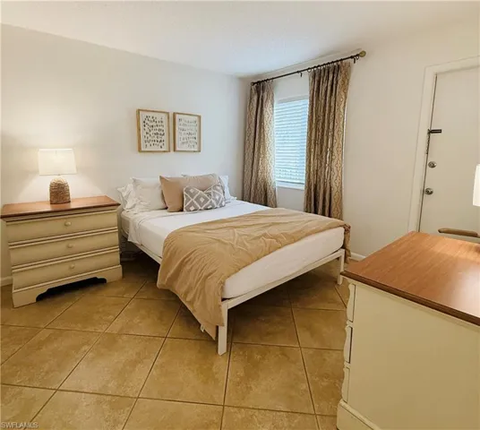 Neutral-toned wall finish with ceramic tile flooring