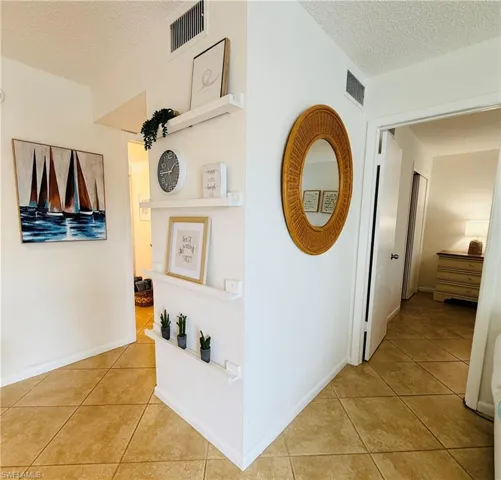 Neutral ceramic tile flooring extends throughout the space