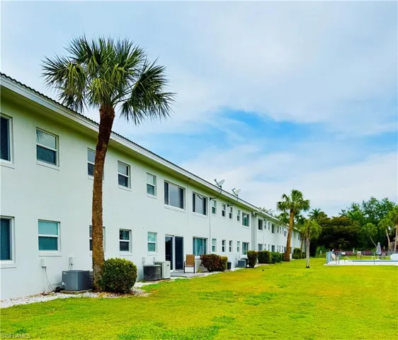 Exterior facade with white stucco finish and multiple windows