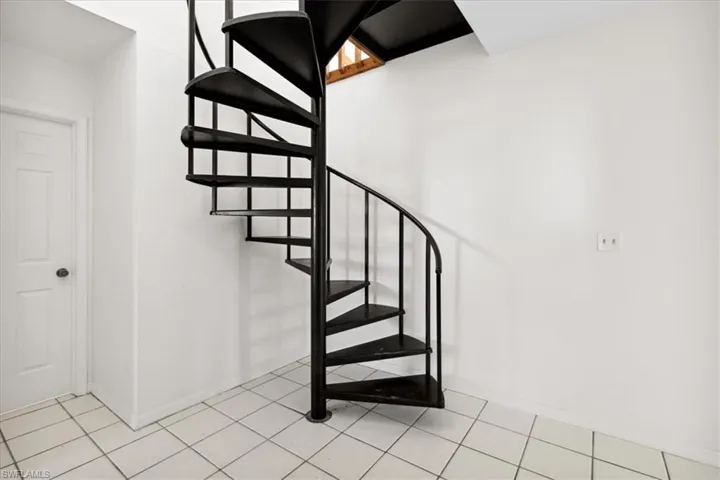 Spiral staircase leading to Primary Bedroom.