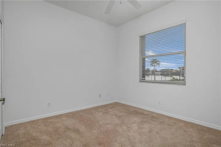 Spare room featuring carpet flooring and ceiling fan