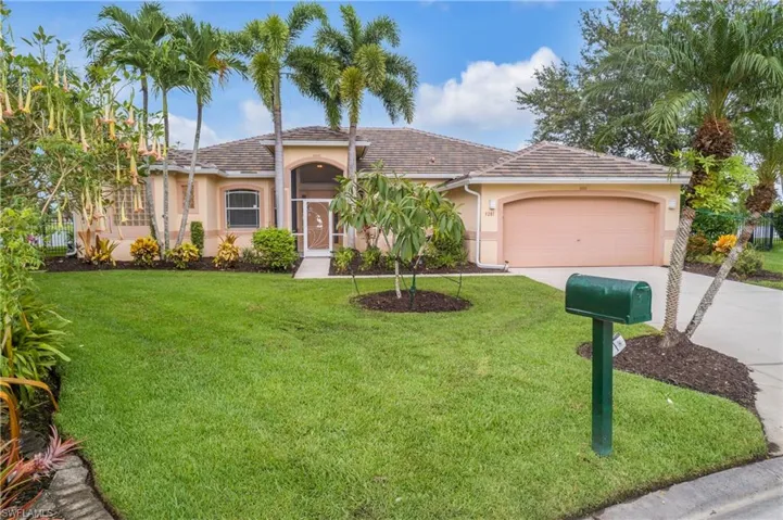 View of front of home featuring a garage and a front yard