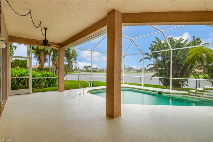 View of pool with ceiling fan, a patio area, and a lanai