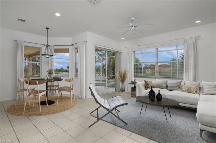 Living room with light tile patterned floors and ceiling fan