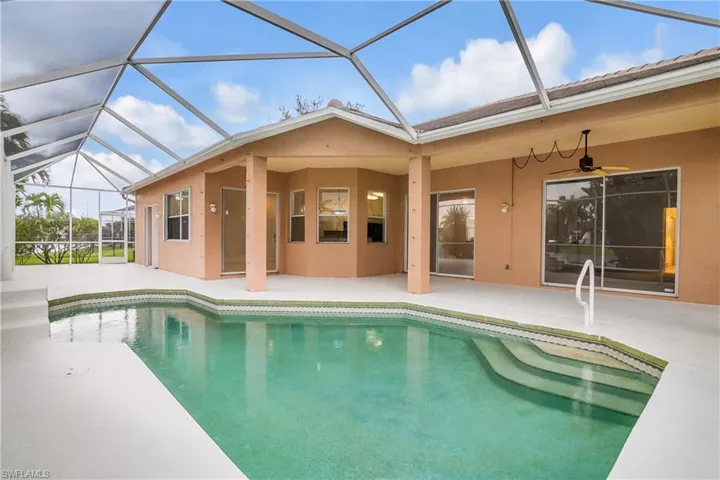 View of swimming pool with a lanai, a patio area, and ceiling fan