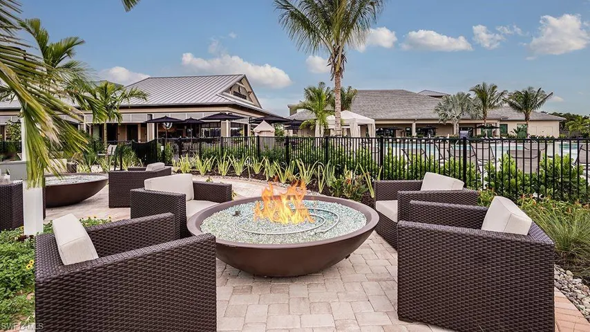 View of patio featuring an outdoor fire pit and fence