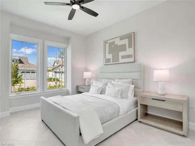 Bedroom with ceiling fan and light tile patterned flooring