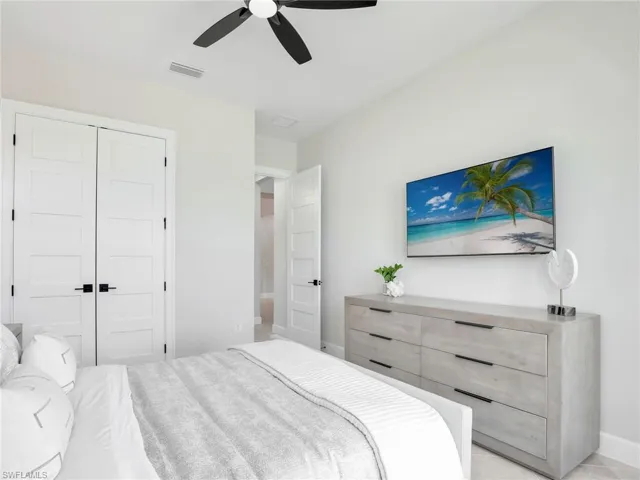 Bedroom with ceiling fan and a closet