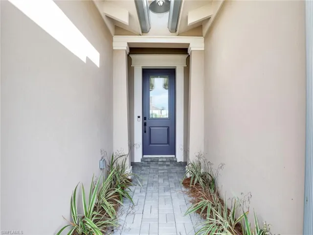 Property entrance featuring stucco siding