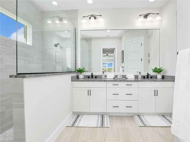 Bathroom with double vanity and walk in shower
