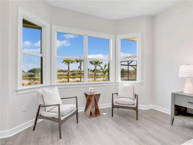Living area with light wood-type flooring and a water view