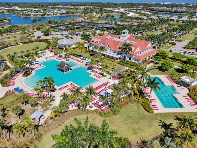 Drone / aerial view of a pool and a large body of water