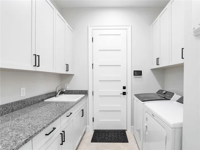 Laundry room featuring washing machine and dryer and cabinet space