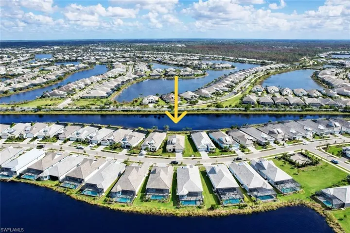 Aerial perspective of suburban area with a nearby body of water