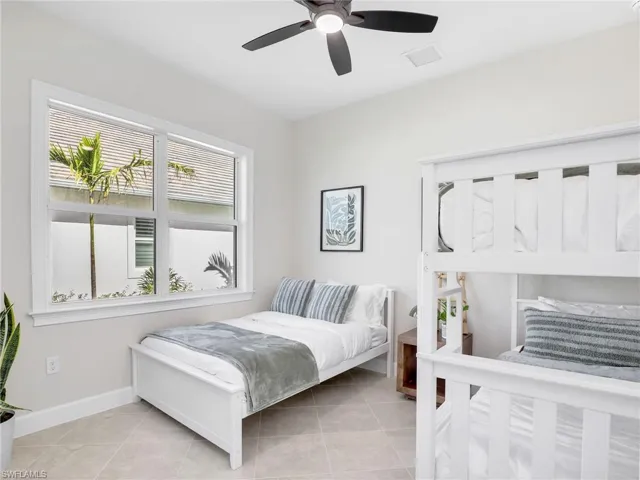 Bedroom featuring a ceiling fan and light tile patterned floors
