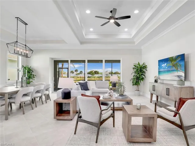 Living room with ceiling fan, recessed lighting, and ornamental molding