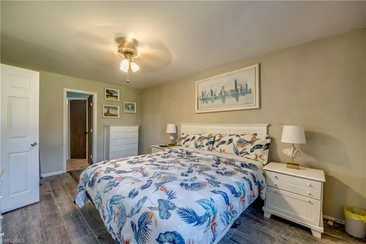 Bedroom featuring dark wood-style floors and ceiling fan