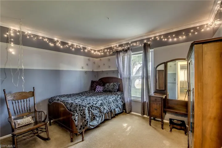 Bedroom with baseboards and carpet