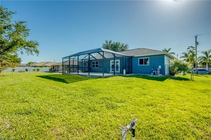 Rear view of property featuring glass enclosure and a patio area