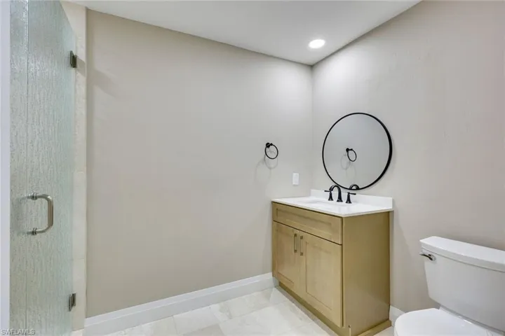 Guest bathroom features a walk-in shower.