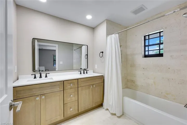 Ensuite primary bathroom features dual vanities.