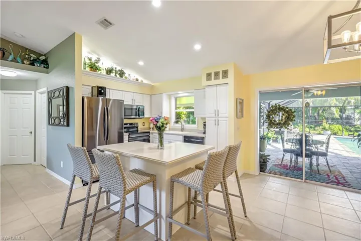 Updated kitchen with white cabinetry, stainless Steel appliances and quartz countertops.