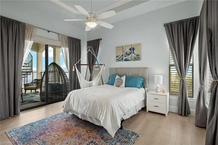 Bedroom with ceiling fan and light hardwood / wood-style flooring