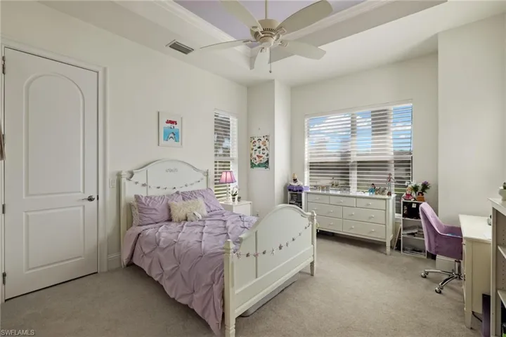 Bedroom with light carpet and ceiling fan