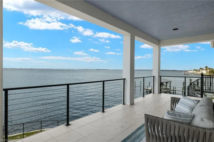 Balcony featuring an outdoor hangout area and a water view
