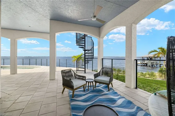 View of patio / terrace featuring ceiling fan and a water view