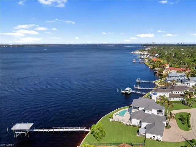 Birds eye view of property with a water view